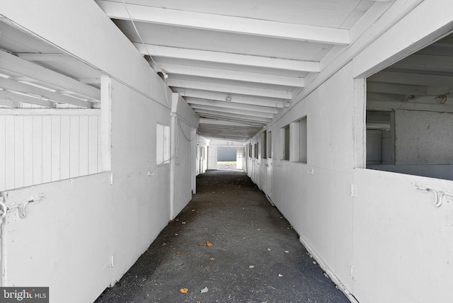 hallway featuring vaulted ceiling with beams