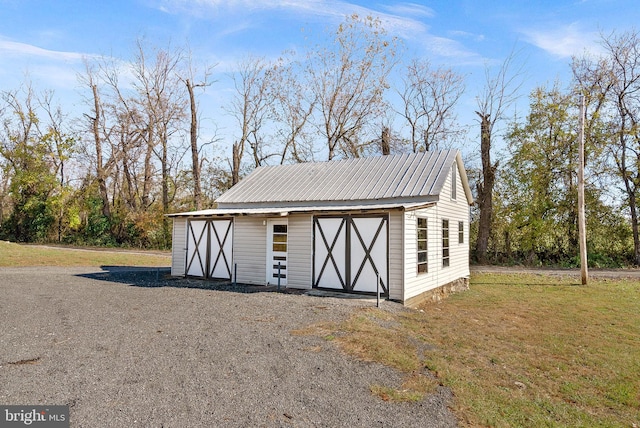 view of outbuilding featuring a yard