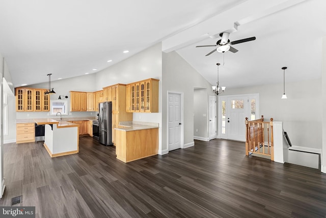 kitchen featuring decorative light fixtures, stainless steel fridge, dark hardwood / wood-style flooring, and beam ceiling