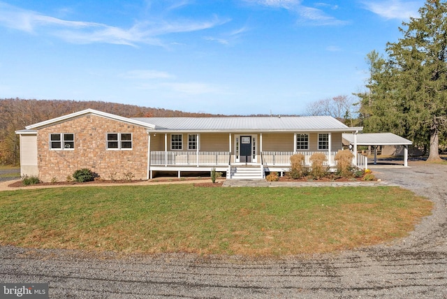 ranch-style house with a carport, covered porch, and a front yard