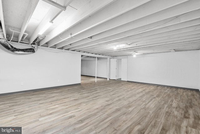 basement with hardwood / wood-style flooring