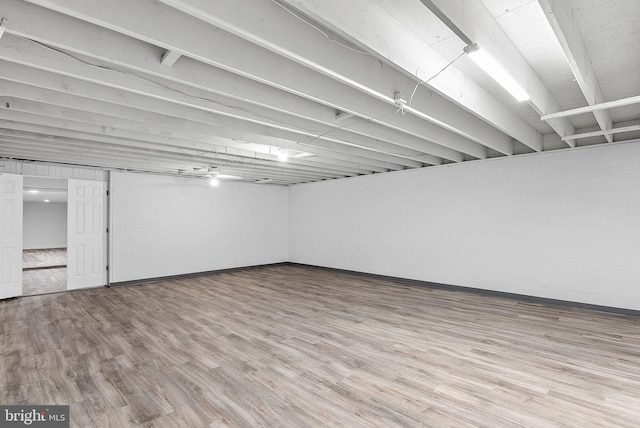 basement with light hardwood / wood-style flooring