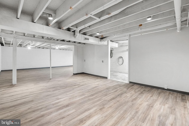 basement featuring hardwood / wood-style flooring