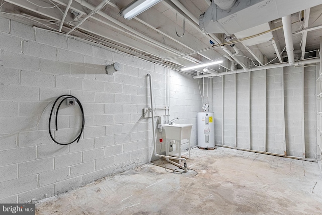 basement featuring sink and water heater