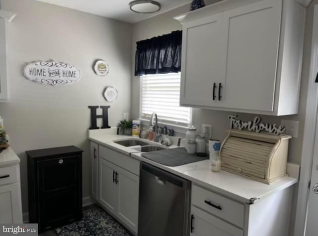 kitchen featuring white cabinets, dishwasher, and sink