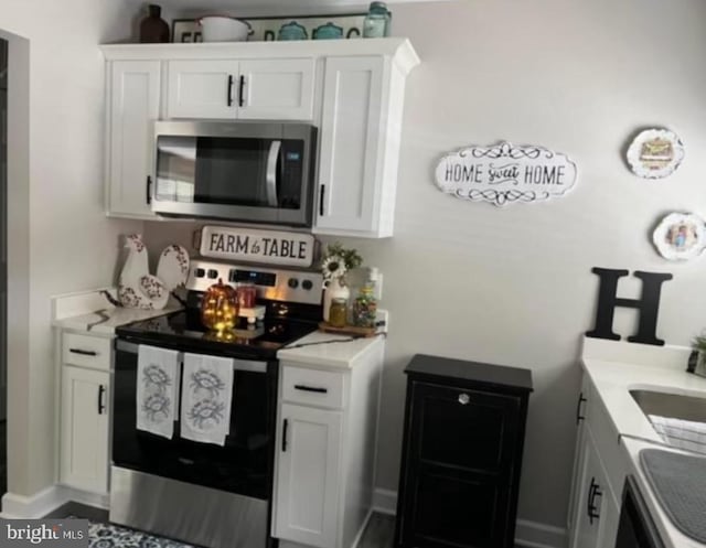 kitchen with white cabinetry and stainless steel appliances