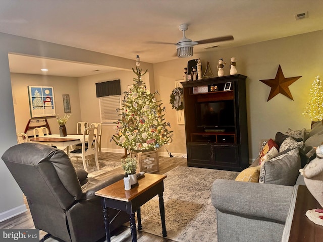 living room with ceiling fan and hardwood / wood-style flooring