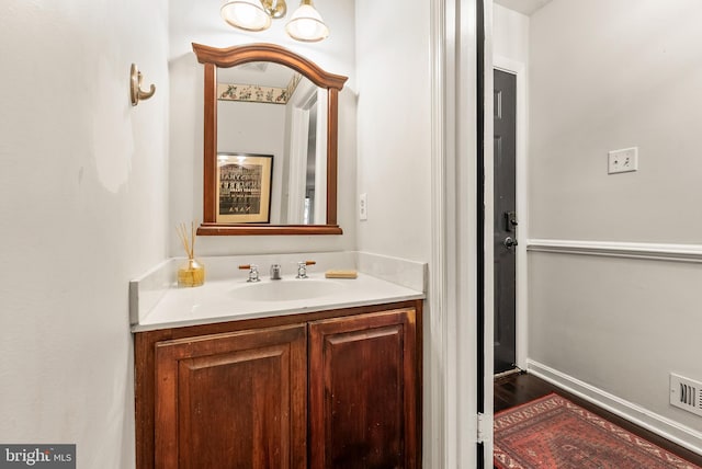 bathroom with vanity and hardwood / wood-style flooring