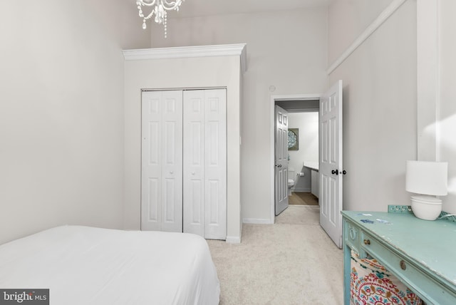 carpeted bedroom with a chandelier and a closet