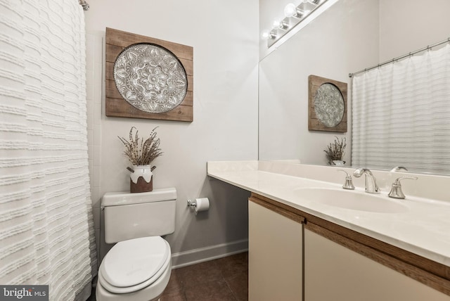 bathroom with tile patterned flooring, vanity, and toilet