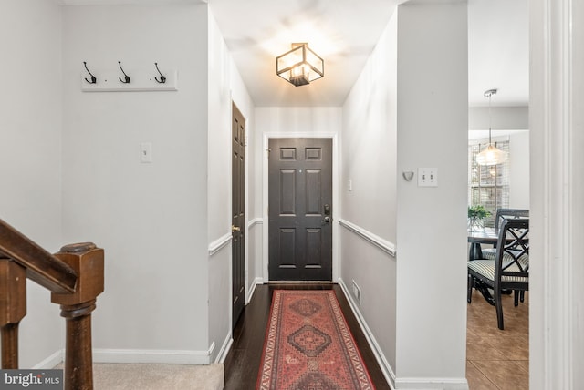 entryway with dark hardwood / wood-style flooring