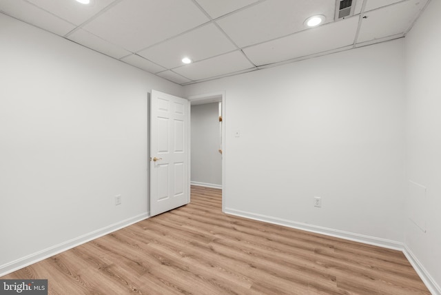 unfurnished room featuring a paneled ceiling and light hardwood / wood-style flooring