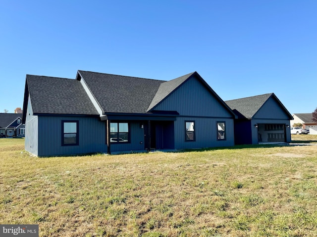 view of front of home with a garage and a front lawn