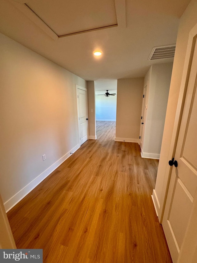 hallway with light hardwood / wood-style floors