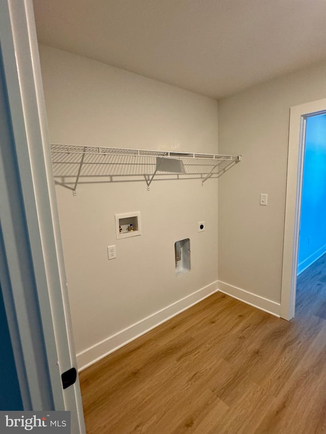 laundry area with hardwood / wood-style floors, washer hookup, and electric dryer hookup