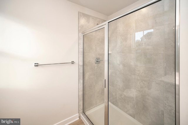 bathroom featuring a shower with shower door