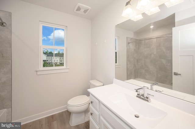 bathroom featuring toilet, vanity, and hardwood / wood-style floors