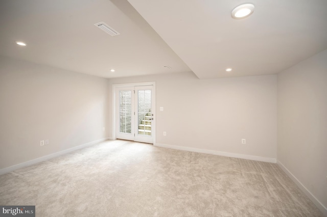 unfurnished room with light colored carpet