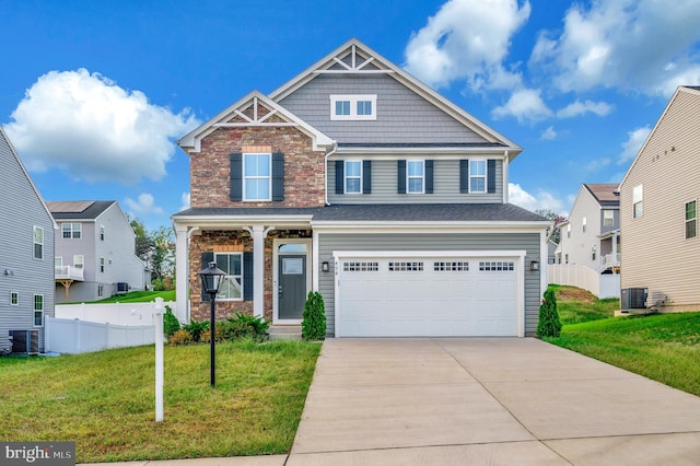 craftsman-style house featuring a garage, central AC, and a front yard