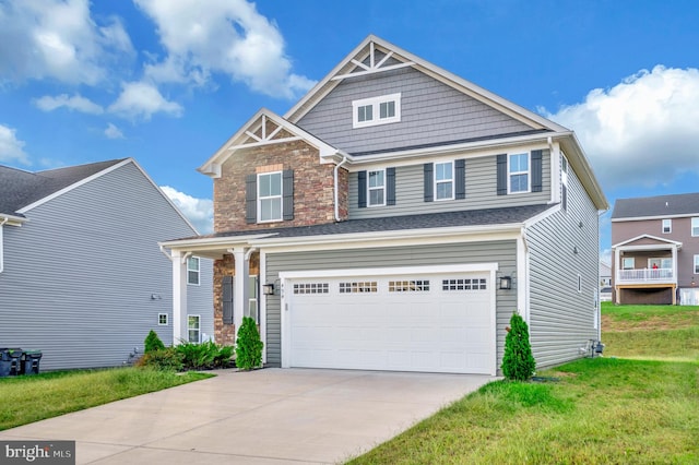 craftsman house with a front lawn and a garage