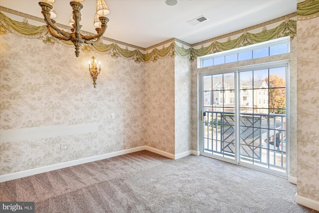 unfurnished room with carpet and an inviting chandelier