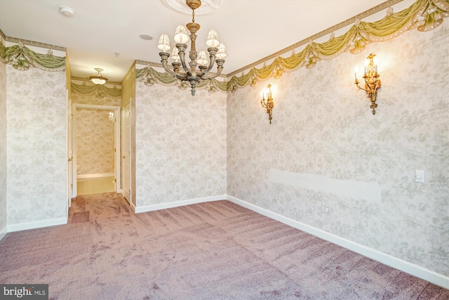 unfurnished dining area featuring crown molding, carpet, and a notable chandelier