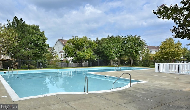 view of swimming pool with a patio