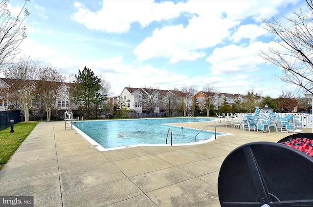 view of swimming pool with a patio area