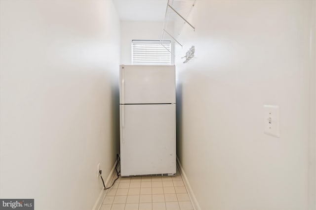 kitchen with white fridge and light tile patterned floors