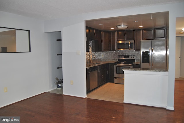 kitchen featuring sink, appliances with stainless steel finishes, and light hardwood / wood-style flooring