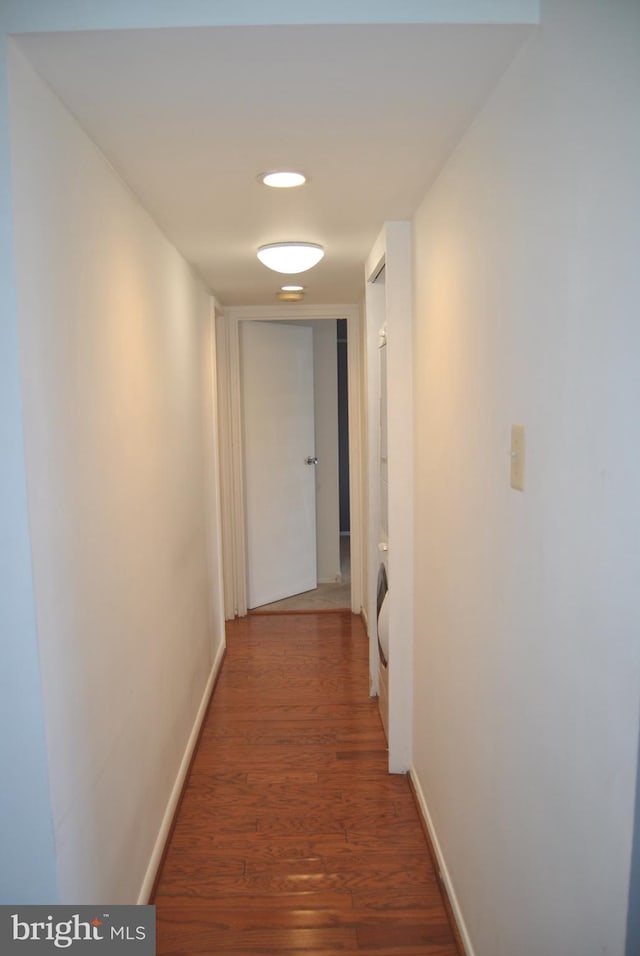 corridor with dark hardwood / wood-style floors