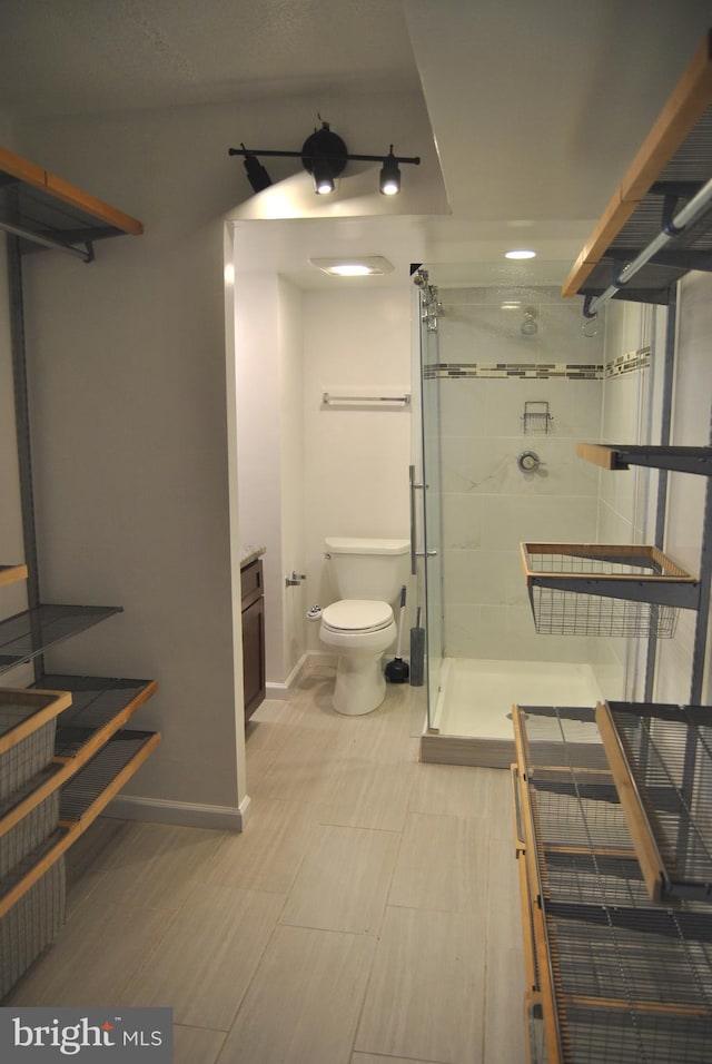 bathroom featuring toilet and walk in shower