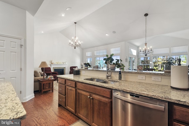 kitchen featuring dark hardwood / wood-style flooring, stainless steel dishwasher, light stone counters, and an inviting chandelier