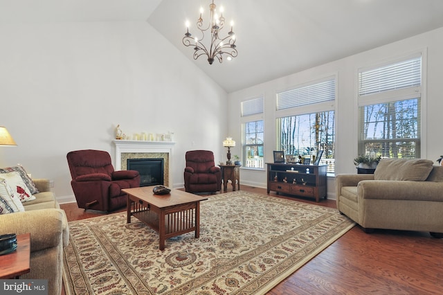 30773 Fowlers Path, Millsboro, DE 19966 - living room with a chandelier, high vaulted ceiling, a glass covered fireplace, and wood finished floors