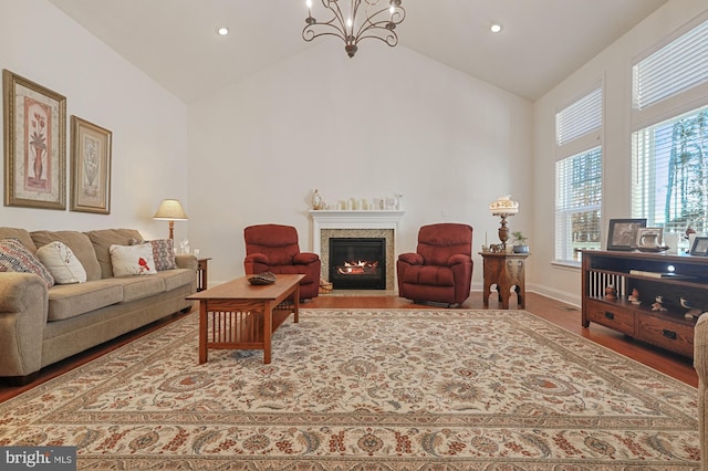30773 Fowlers Path, Millsboro, DE 19966 - living room featuring a fireplace with flush hearth, a chandelier, high vaulted ceiling, wood finished floors, and recessed lighting