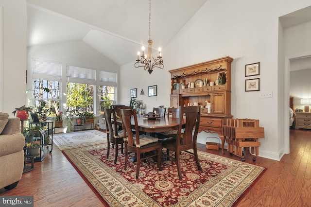 dining room with high vaulted ceiling, an inviting chandelier, and wood-type flooring