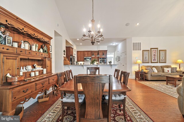 30773 Fowlers Path, Millsboro, DE 19966 - dining area with a chandelier, wood finished floors, lofted ceiling, and recessed lighting