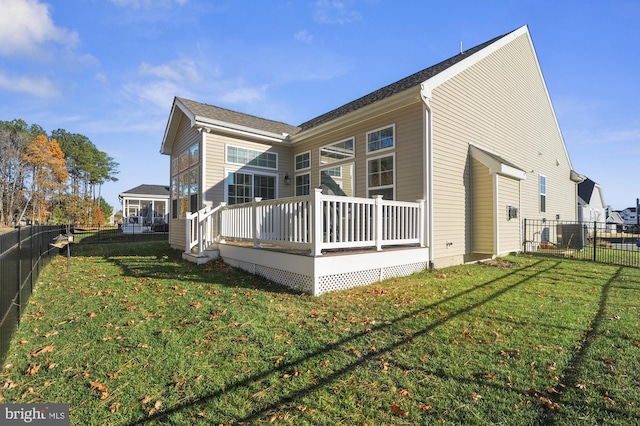 view of side of home featuring a deck and a yard