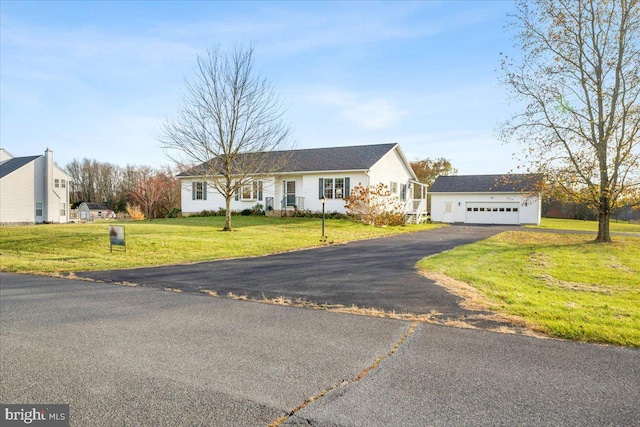 ranch-style home with a front lawn, an outdoor structure, and a garage