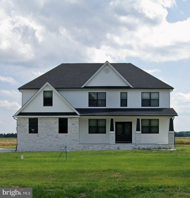 view of front facade featuring covered porch and a front yard