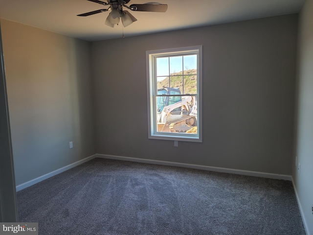 spare room featuring ceiling fan, baseboards, and dark colored carpet