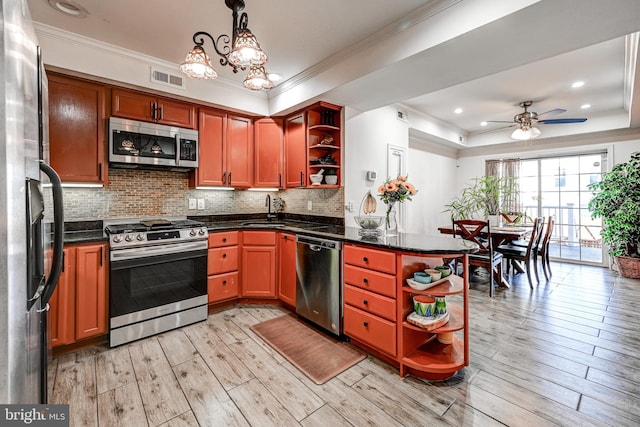 kitchen featuring pendant lighting, stainless steel appliances, light hardwood / wood-style floors, and crown molding