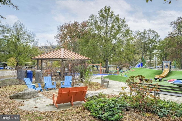 view of home's community featuring a playground and a yard