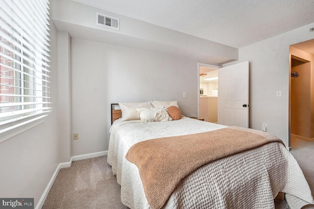 carpeted bedroom featuring a textured ceiling