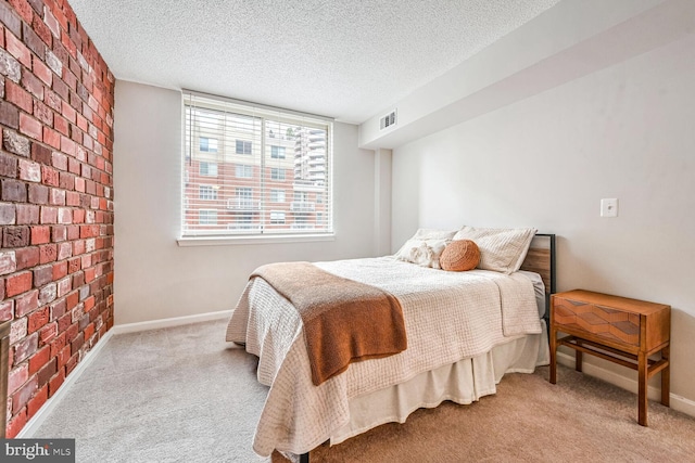 bedroom featuring light colored carpet and a textured ceiling