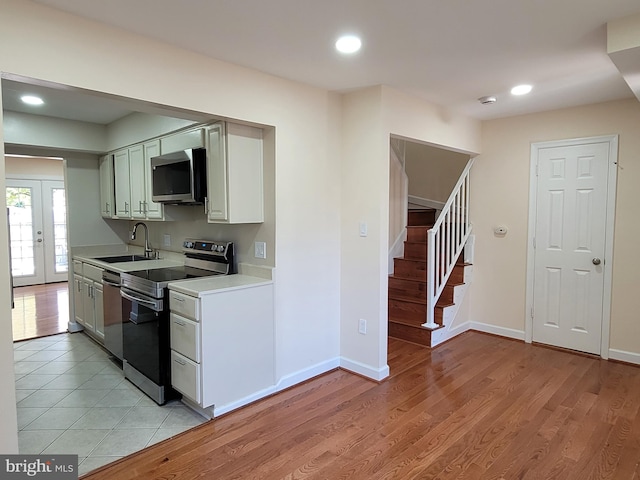 kitchen with sink, light hardwood / wood-style flooring, and appliances with stainless steel finishes