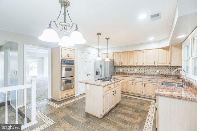 kitchen with stainless steel appliances, dark wood-type flooring, sink, tasteful backsplash, and a kitchen island