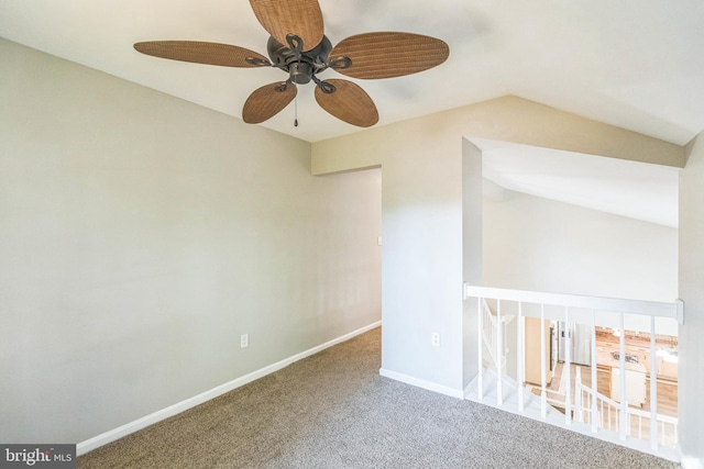 carpeted spare room featuring lofted ceiling and ceiling fan