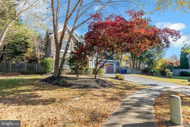 view of front of property with a garage and a front lawn