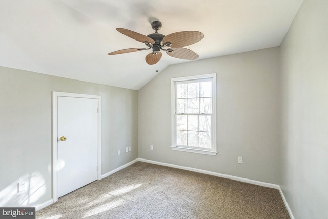 interior space with lofted ceiling, ceiling fan, and carpet floors